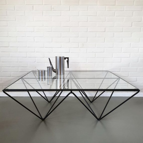 Salontafel / Coffee Table in de stijl van ALANDA by Paolo Piva for B&B Italia - Geometrisch en luchtig vormgegeven onderstel van zwart gelakt metaal met een blad van dik glas - heeft een chipje en krasjes - Jaren 80 Postmodern design, 100x100x35cm - € 225